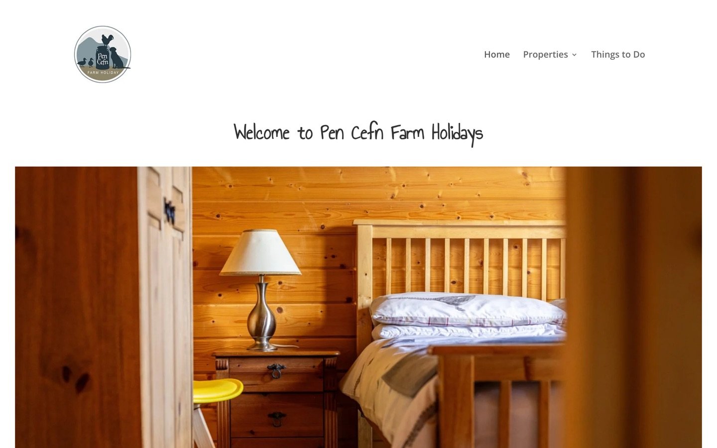The Pen Cefn Farm Holidays homepage on a laptop